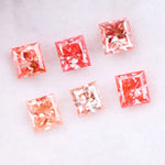 Six square princess cut pink lab grown diamonds in varying shades from light blush to vivid pink, displayed on a white background, featuring brilliant faceting and high clarity for luxury jewelry settings.