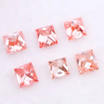 Six square princess cut pink lab grown diamonds in varying shades from light blush to vivid pink, displayed on a white background, featuring brilliant faceting and high clarity for luxury jewelry settings.