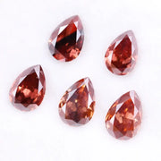 Five pear-shaped lab grown diamonds in fancy deep pinkish red color arranged on a white background, featuring brilliant faceting and teardrop cut for engagement rings and custom fine jewelry.