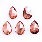 Five pear-shaped lab grown diamonds in fancy deep pinkish red color arranged on a white background, featuring brilliant faceting and teardrop cut for engagement rings and custom fine jewelry.