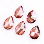Five pear-shaped lab grown diamonds in fancy deep pinkish red color arranged on a white background, featuring brilliant faceting and teardrop cut for engagement rings and custom fine jewelry.