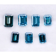 Close-up of emerald-cut lab-grown blue diamonds showcasing exceptional clarity and vibrant color, ideal for high-end jewelry designs.