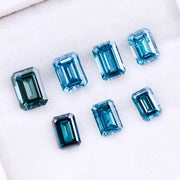 Close-up of emerald-cut lab-grown blue diamonds showcasing exceptional clarity and vibrant color, ideal for high-end jewelry designs.
