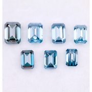 Close-up of emerald-cut lab-grown blue diamonds showcasing exceptional clarity and vibrant color, ideal for high-end jewelry designs.