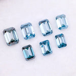 Close-up of emerald-cut lab-grown blue diamonds showcasing exceptional clarity and vibrant color, ideal for high-end jewelry designs.