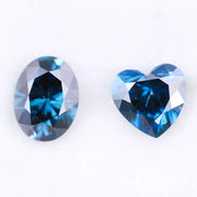 Oval and heart shaped fancy deep blue lab grown diamonds with brilliant faceting, showcasing vivid teal blue tones and VS clarity on a white background.