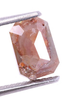 radiant shape loose diamond held by tweezers on a white background