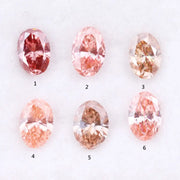 Six oval cut pink lab grown diamonds in varying shades from vivid rose and blush pink to soft peach and champagne, displayed on a white background, showcasing brilliant faceting and exceptional sparkle.