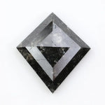 sharp kite cut rustic black diamond gemstone showcasing brilliant, highly reflective facets across a sleek triangular silhouette.