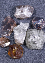 Raw diamonds on a dark gray background