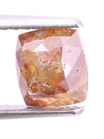 natural diamond held by tweezers on a white background