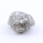 Natural grey diamond loose stone with raw texture and smoky charcoal tone for custom engagement ring design.