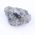 Close-up of rough diamond stone highlighting its natural shape and pristine unpolished surface for jewelry.