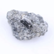 Close-up of rough diamond stone highlighting its natural shape and pristine unpolished surface for jewelry.