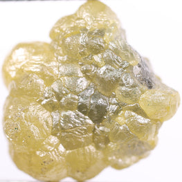 Yellow rough held by tweezers on a white background