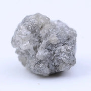 Close-up of rough diamond emphasizing natural sparkle and irregular, uncut crystal surfaces.