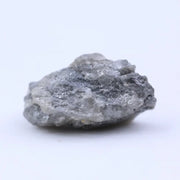 Natural diamond in raw form with subtle sparkle and rugged, organic shape.