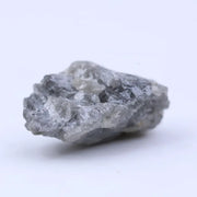 Natural diamond in raw form with subtle sparkle and rugged, organic shape.