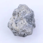 Raw natural diamond crystal before cutting with irregular shape and natural sparkle under light