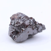 Uncut red tone rough diamond crystal with natural color variation and raw gemstone texture