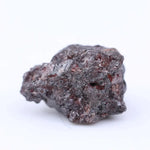 Uncut red tone rough diamond crystal with natural color variation and raw gemstone texture