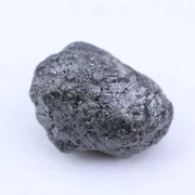 Natural black diamond loose gemstone with deep dark color and raw crystal texture.
