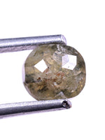 Faceted diamond held by tweezers on a white background