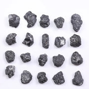 Black diamond with deep dark color displayed in a polished luxury jewelry setting