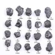 Black diamond with deep dark color displayed in a polished luxury jewelry setting