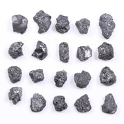 Black diamond with deep dark color displayed in a polished luxury jewelry setting