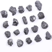 Black diamond with deep dark color displayed in a polished luxury jewelry setting