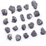 Black diamond with deep dark color displayed in a polished luxury jewelry setting