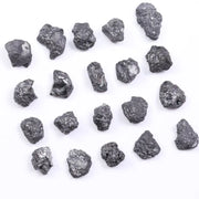 Black diamond with deep dark color displayed in a polished luxury jewelry setting