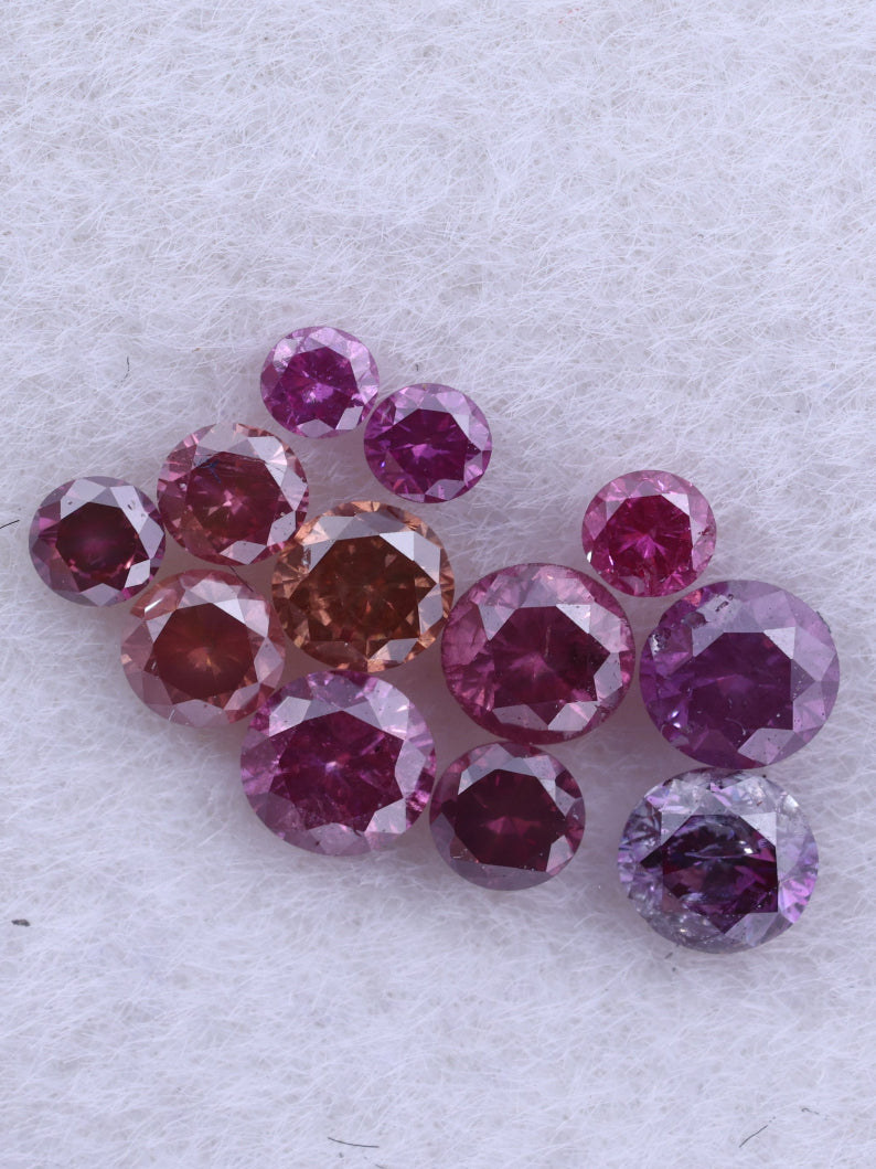 Cluster of pink and red diamonds on a light gray background