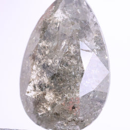 Teardrop-shaped diamond held between tweezers on a white background