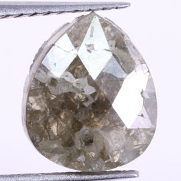 Teardrop-shaped diamond held between tweezers on a white background