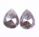 Two teardrop-shaped gemstones on a white background