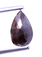 pear shape held by tweezers on a white background