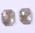 Two faceted diamond on a light gray background