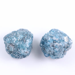 Pair of blue glittery stud earrings on a white background