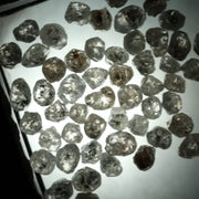 Natural grey white rough diamond lot with mixed silver smoky tones, raw uncut loose diamond crystals displayed on white background.