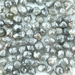 Mixed silver smoky raw uncut loose diamond crystals in natural grey and translucent white tones, rough earth-mined diamonds for jewelry making.