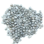 Mixed silver smoky raw uncut loose diamond crystals in natural grey and translucent white tones, rough earth-mined diamonds for jewelry making.