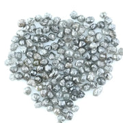 Mixed silver smoky raw uncut loose diamond crystals in natural grey and translucent white tones, rough earth-mined diamonds for jewelry making.