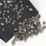 brown grey natural diamond with an untreated rough surface for jewelry creation