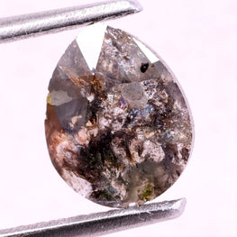 Brown natural diamond held by tweezers on a white background