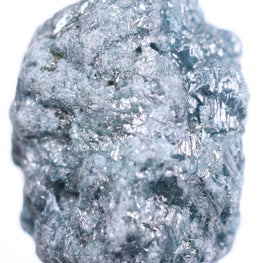 Raw diamond held by tweezers on a white background
