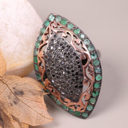 Victorian marquise black diamond ring with an emerald halo in a sterling silver cocktail setting.