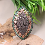 Victorian marquise black diamond ring with an emerald halo in a sterling silver cocktail setting.