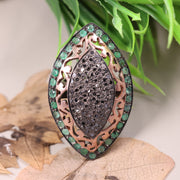 Victorian marquise black diamond ring with an emerald halo in a sterling silver cocktail setting.